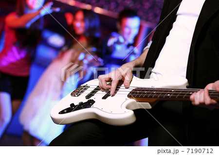 Young guitar player performing in night club 7190712
