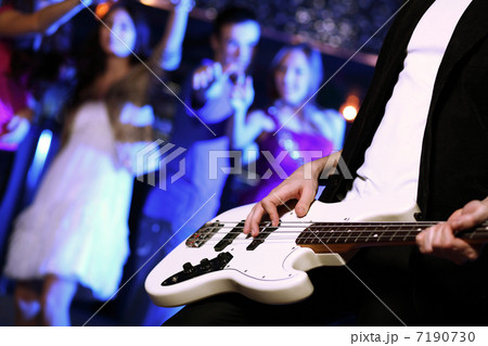 Young guitar player performing in night club 7190730