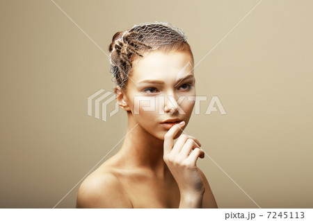 Fantasy. Creative Concept. Tarantula Spider on Woman's Head sitting in Metallic Cobweb 7245113