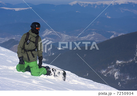 Snowboarder on the Brink of a Precipice 7250934