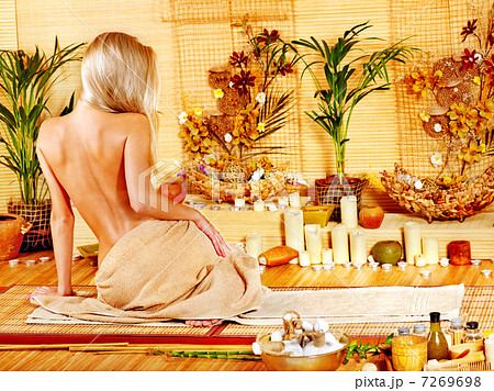 Woman getting massage in bamboo spa. 7269698
