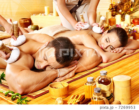 Man and woman getting herbal ball massage in spa. Man and woman getting herbal ball massage in spa. 7269953