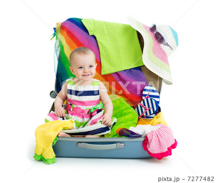 Baby girl sitting in suitcase with things for vacation travel Baby girl sitting in suitcase with things for vacation travel 7277482