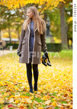 Girl on a fall day, with her shoes in hand Girl on a fall day, with her shoes in hand 7281234