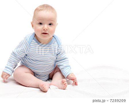 Child sitting on white bed 7289209