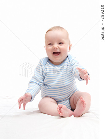 beautiful laughing happy baby boy sitting on white bed 7289210