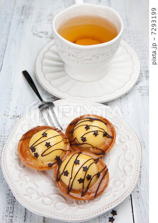 Sweet cakes with cup of tea on white table 7293199