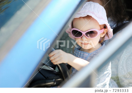 Adorable toddler girl sitting in a car Adorable toddler girl sitting in a car 7293333