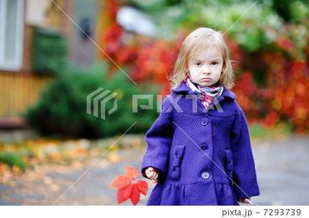 Little girl in bright blue coat at autumn Little girl in bright blue coat at autumn 7293739