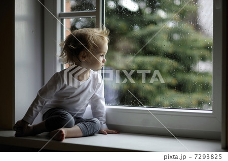 Adorable toddler girl looking at raindrops Adorable toddler girl looking at raindrops 7293825