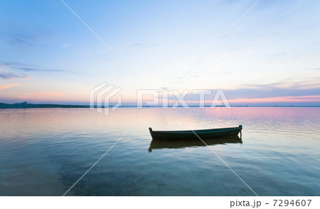 sunset and boat on summer lake bank 7294607