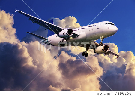 Jet plane is maneuvering for landing in a sunset sky 7296256