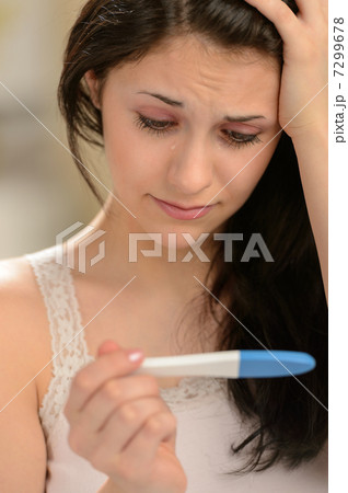 Distraught girl waiting for pregnancy test result 7299678
