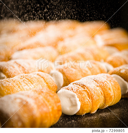 Powder sugar falling on to cream horns 7299805