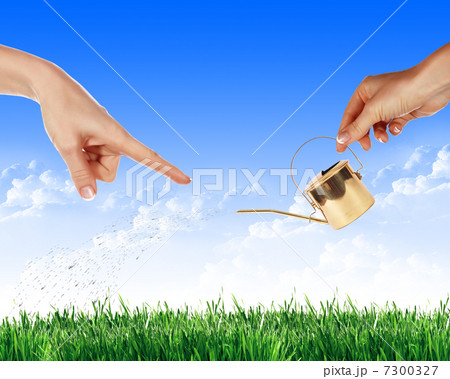 Hand with a small watering Hand with a small watering 7300327