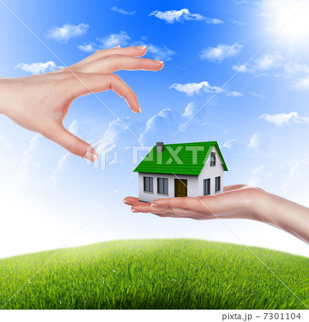 House in the hands against the blue sky 7301104