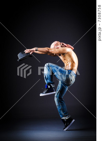 Dancer dancing in dark room 7308758