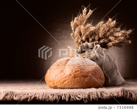 Bread, flour sack and ears bunch still life 7316998