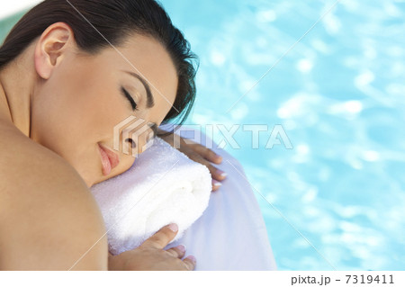 Beautiful Young Woman Relaxing By Pool At Health Spa Beautiful Young Woman Relaxing By Pool At Health Spa 7319411
