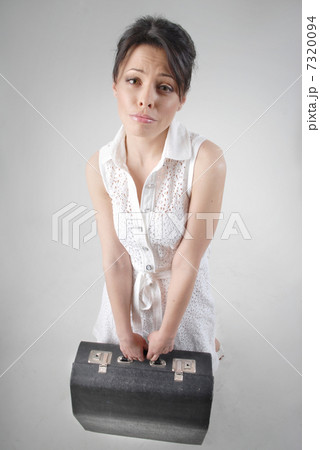 begging brunette with travel bag in white dress begging brunette with travel bag in white dress 7320094