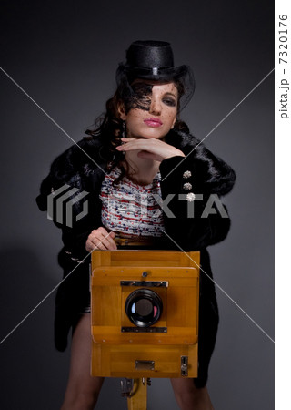 Old-style portrait of lady with vintage camera 7320176