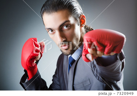 Businessman with boxing gloves on white Businessman with boxing gloves on white 7320949