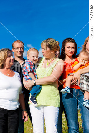 Family and multi-generation - fun on meadow in summer 7323368