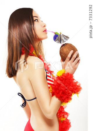 Japanese Woman Drinking Exotic Cocktail through the Straw and Relaxing. Travel Concept Japanese Woman Drinking Exotic Cocktail through the Straw and Relaxing. Travel Concept 7331292
