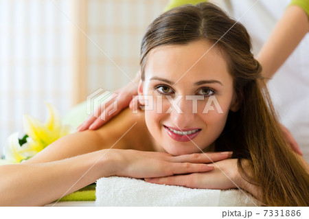 woman having a wellness back massage woman having a wellness back massage 7331886