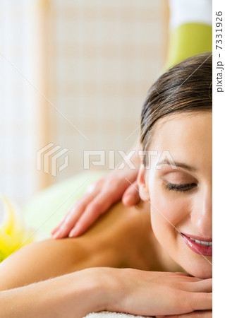woman having a wellness back massage woman having a wellness back massage 7331926