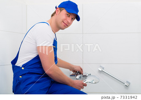 Plumber repairing shower in bath room 7331942