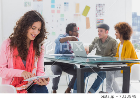 Smiling designer using digital tablet 7333949