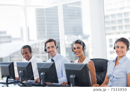 Line of call centre employees smiling 7333950