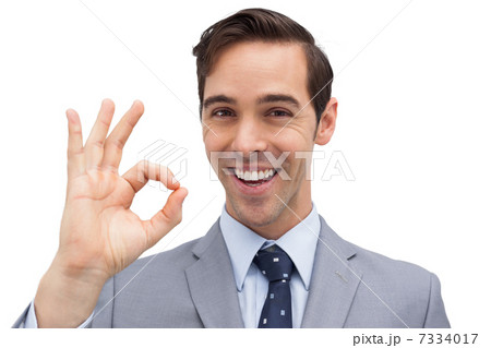 Successful businessman giving ok sign 7334017