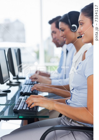 Cheerful team of call centre employees Cheerful team of call centre employees 7334117