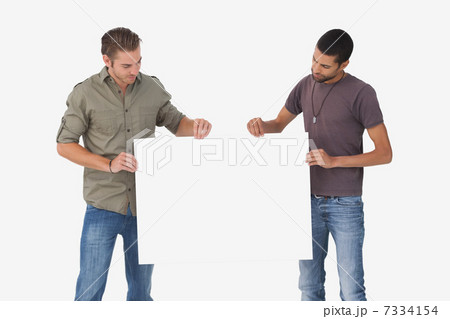 Attractive men holding blank card and looking at it Attractive men holding blank card and looking at it 7334154
