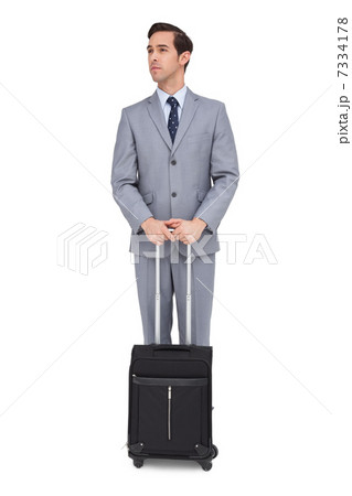 Serious businessman waiting with his luggage Serious businessman waiting with his luggage 7334178