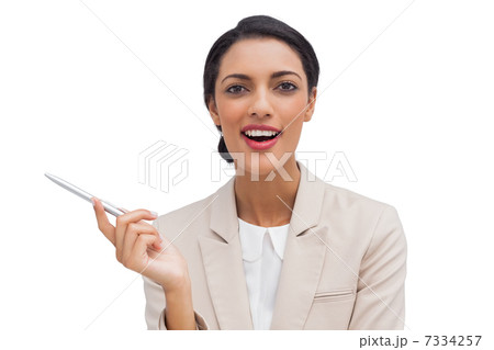Smiling businesswoman holding a pen Smiling businesswoman holding a pen 7334257