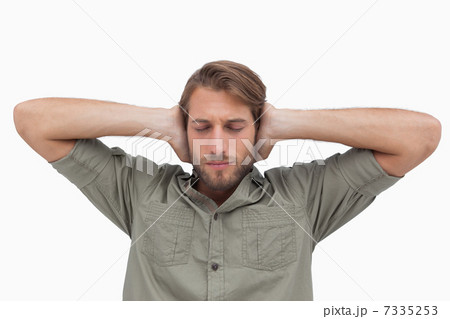 Man blocking his ears and closing his eyes Man blocking his ears and closing his eyes 7335253