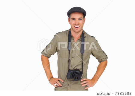Smiling man in peaked cap with camera around his neck 7335288