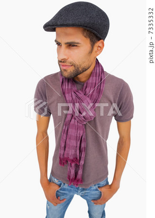 Thougthful man wearing peaked cap and scarf 7335332