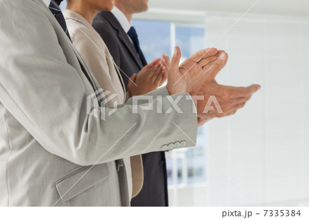 Business people applauding together Business people applauding together 7335384