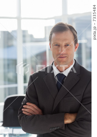 Confident businessman with arms folded Confident businessman with arms folded 7335484