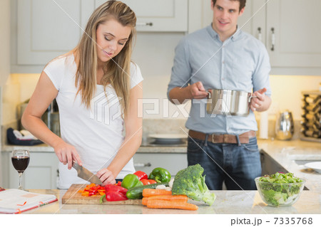 Man helping woman with cooking 7335768