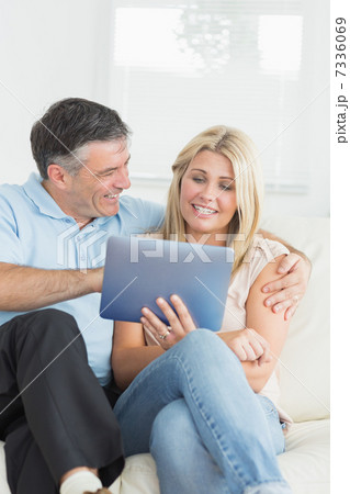 Wife and husband using tablet pc together Wife and husband using tablet pc together 7336069