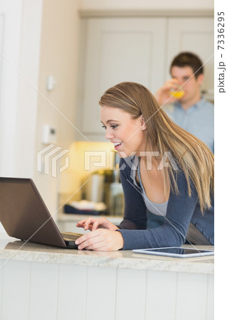 Woman talking via Webcam with man drinking orange juice 7336295