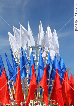 colored flags on a blue sky background 7337232