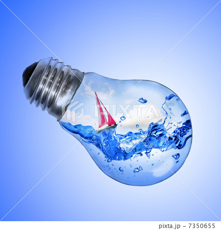 Energy concept. Light bulb with water and yacht inside isolated Energy concept. Light bulb with water and yacht inside isolated 7350655