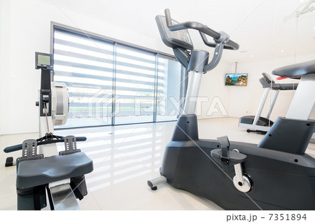 Exercise bike and rowing simulator in a modern luxe gym. Indoor. 7351894