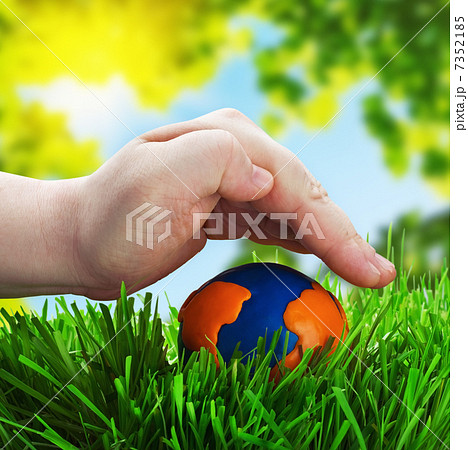 man's hand on a globe made of plasticine 7352185